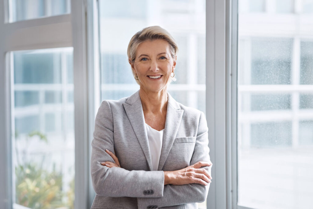 Business woman standing in front of windows
